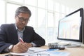 Asian senior business man working on computer table for office l Royalty Free Stock Photo