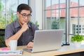 Asian senior business man working online on a modern laptop computer