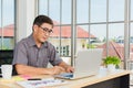 Asian senior business man working online on a modern laptop computer Royalty Free Stock Photo