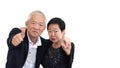 Asian senior couple in business attire showing hand gesture thumb up and pointing Royalty Free Stock Photo