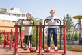 asian senior couple doing exercise at gym machine in park Royalty Free Stock Photo
