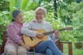 Asian senior couple elderly man playing guitar while his wife singing together Royalty Free Stock Photo