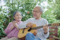 Asian senior couple elderly man playing guitar while his wife singing together Royalty Free Stock Photo