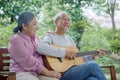 senior couple elderly man playing guitar while his wife singing together Royalty Free Stock Photo