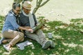 Asian senior couple or elderly people siting at garden