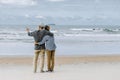 Asian senior couple or elderly people walking and siting at the beach