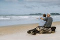 Asian senior couple or elderly people walking and siting at the beach