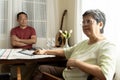 Asian senior couple having relationship problems, angry at each other sitting at the dining table Royalty Free Stock Photo