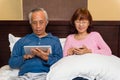 Asian senior couple with mobile technology Royalty Free Stock Photo