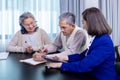 Asian senior couple signing legal financial contract and insurance health care benefit for retirement home visit service by Royalty Free Stock Photo