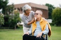 Asian Senior couple sitting in wheelchairs taking care of each other.in romantic time They laughing and smiling while sitting Royalty Free Stock Photo