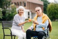 Asian Senior couple sitting in wheelchairs taking care of each other.in romantic time They laughing and smiling while sitting Royalty Free Stock Photo