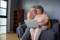 Asian senior couple talking in video call chat on laptop computer.