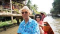 Asian senior couple travel to thailand cruising on the boat in f Royalty Free Stock Photo