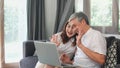 Asian senior couple video call at home. Asian Senior Chinese grandparents, using laptop video call talking with family grandchild Royalty Free Stock Photo