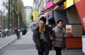 Asian senior couple walking along Europe street while traveling