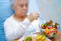 Asian senior eating breakfast in hospital. Royalty Free Stock Photo