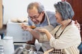 Asian Senior elderly couple standing in kitchen at house feeling happy and enjoy retirement life together. Loving Older grandparen