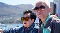 Asian senior elderly couple on tourist ferry boat to seals island trip attracion Fun wildlife watching aticity in South Africa Royalty Free Stock Photo