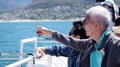 Asian senior elderly couple on tourist ferry boat to seals island trip attracion Fun wildlife watching aticity in South Africa Royalty Free Stock Photo