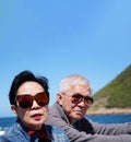 Asian senior elderly couple on tourist ferry boat to seals island trip attracion Fun wildlife watching aticity in South Africa Royalty Free Stock Photo