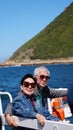 Asian senior elderly couple on tourist ferry boat to seals island trip attracion Fun wildlife watching aticity in South Africa Royalty Free Stock Photo