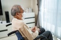 Asian Senior Elderly disabled lonely man wear mask, sit on wheelchair. Mature older guy feel upset while stay at nursing home care Royalty Free Stock Photo