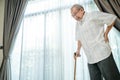 Asian Senior elderly disabled man patient walking slowly with walker or cane at nursing home care. Older handicapped male feeling