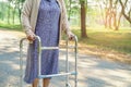 Asian senior or elderly old lady use walker with strong health while walking at park. Royalty Free Stock Photo