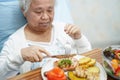 Asian senior or elderly old lady woman patient eating breakfast on bed Royalty Free Stock Photo