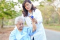 Asian senior or elderly old lady woman patient exercise with dumbbell on wheelchair in park Royalty Free Stock Photo