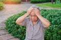 Asian senior or elderly old lady woman patient headache while sitting on bed in nursing hospital ward