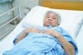Asian senior or elderly old lady woman patient lying on bed in nursing hospital Royalty Free Stock Photo