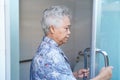 Asian senior elderly old lady woman patient open toilet bathroom by hand in nursing hospital ward. Royalty Free Stock Photo