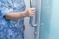 Asian senior elderly old lady woman patient open toilet bathroom by hand in nursing hospital ward Royalty Free Stock Photo