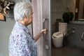 Asian senior elderly old lady woman patient open toilet bathroom by hand in nursing hospital ward, healthy strong medical. Royalty Free Stock Photo