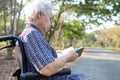 Asian senior or elderly old lady woman patient reading a book while sitting on bed in nursing hospital ward, healthy strong Royalty Free Stock Photo