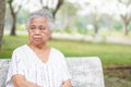Asian senior or elderly old lady woman patient sitting on chair in park with hope and waiting her relative Royalty Free Stock Photo
