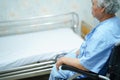 Asian senior or elderly old lady woman patient sitting on  wheelchair with bed at nursing hospital Royalty Free Stock Photo