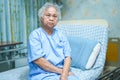 Asian senior or elderly old lady woman patient smile bright face while sitting on bed in nursing hospital Royalty Free Stock Photo