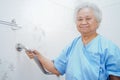 Asian senior or elderly old lady woman patient use toilet bathroom handle security Royalty Free Stock Photo