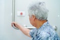 Asian senior or elderly old lady woman patient use toilet bathroom handle security in nursing hospital ward Royalty Free Stock Photo