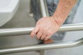 Asian senior or elderly old lady woman patient use toilet bathroom handle security in nursing hospital ward Royalty Free Stock Photo