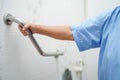 Asian senior or elderly old lady woman patient use toilet bathroom handle security in nursing hospital ward Royalty Free Stock Photo