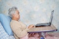 Asian senior or elderly old lady woman patient using notebook computer Royalty Free Stock Photo