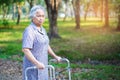 Asian senior or elderly old lady woman patient walk with walker in park Royalty Free Stock Photo