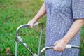 Asian senior or elderly old lady woman patient walk with walker in park Royalty Free Stock Photo