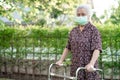 Asian senior or elderly old lady woman patient walk with walker in park with copy space healthy strong medical concept Royalty Free Stock Photo