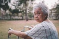 Asian senior or elderly old lady woman patient walk with walker in park with copy space, healthy strong medical. Royalty Free Stock Photo