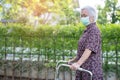 Asian senior or elderly old lady woman patient walk with walker in park,  healthy strong medical concept Royalty Free Stock Photo